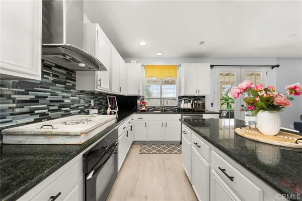a kitchen with a sink stove and cabinets