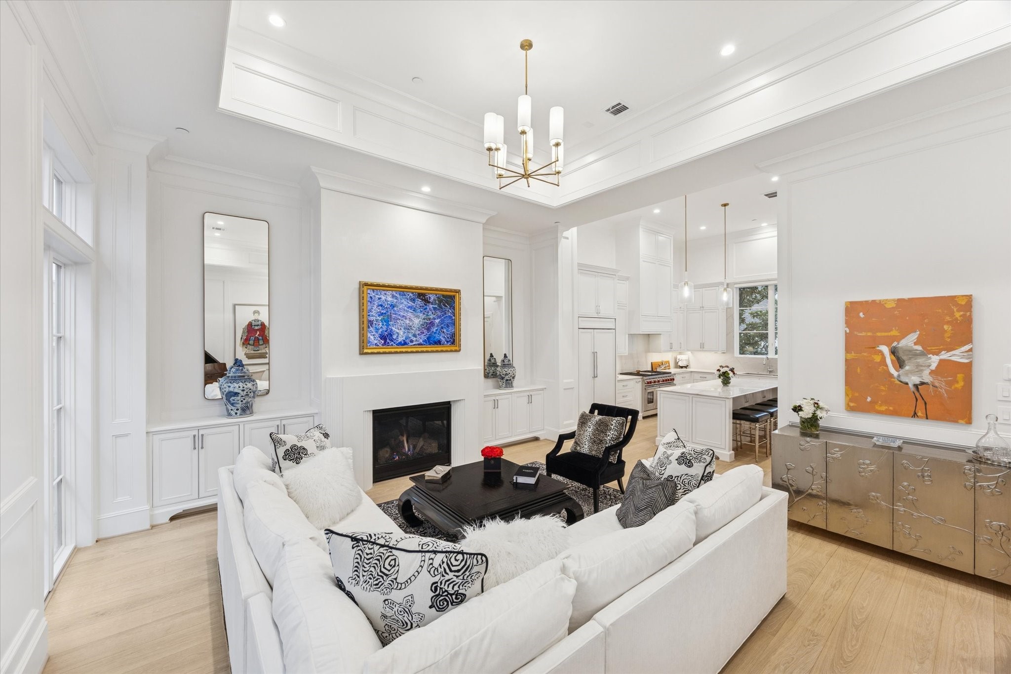 1335 Peden Street Houston, TX 77019 - Photo 1 of 37 a living room with furniture a fireplace and a chandelier