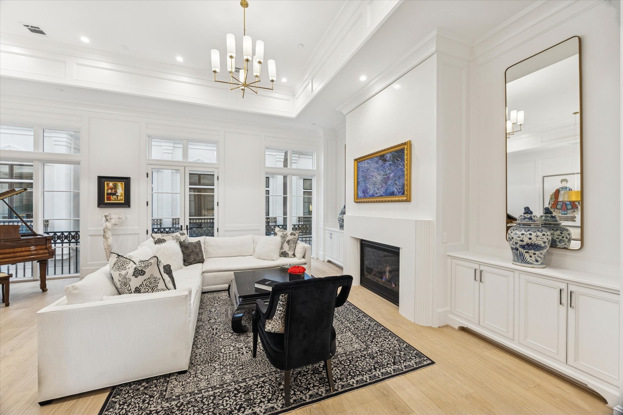 1335 Peden Street Houston, TX 77019 - Photo 11 of 37 a living room with fireplace furniture and a chandelier