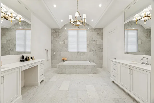 a large spacious bathroom with a tub sink and mirror