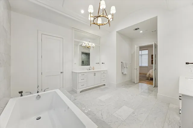 a bathroom with a tub sink and mirror
