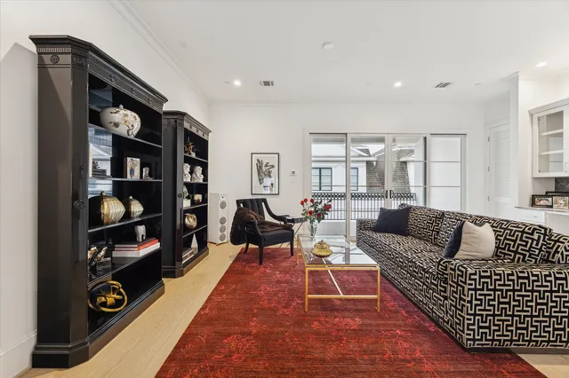 a living room with furniture a rug and a book shelf