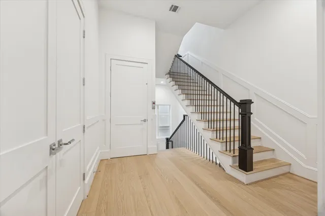 a view of a hallway with wooden floor and entryway
