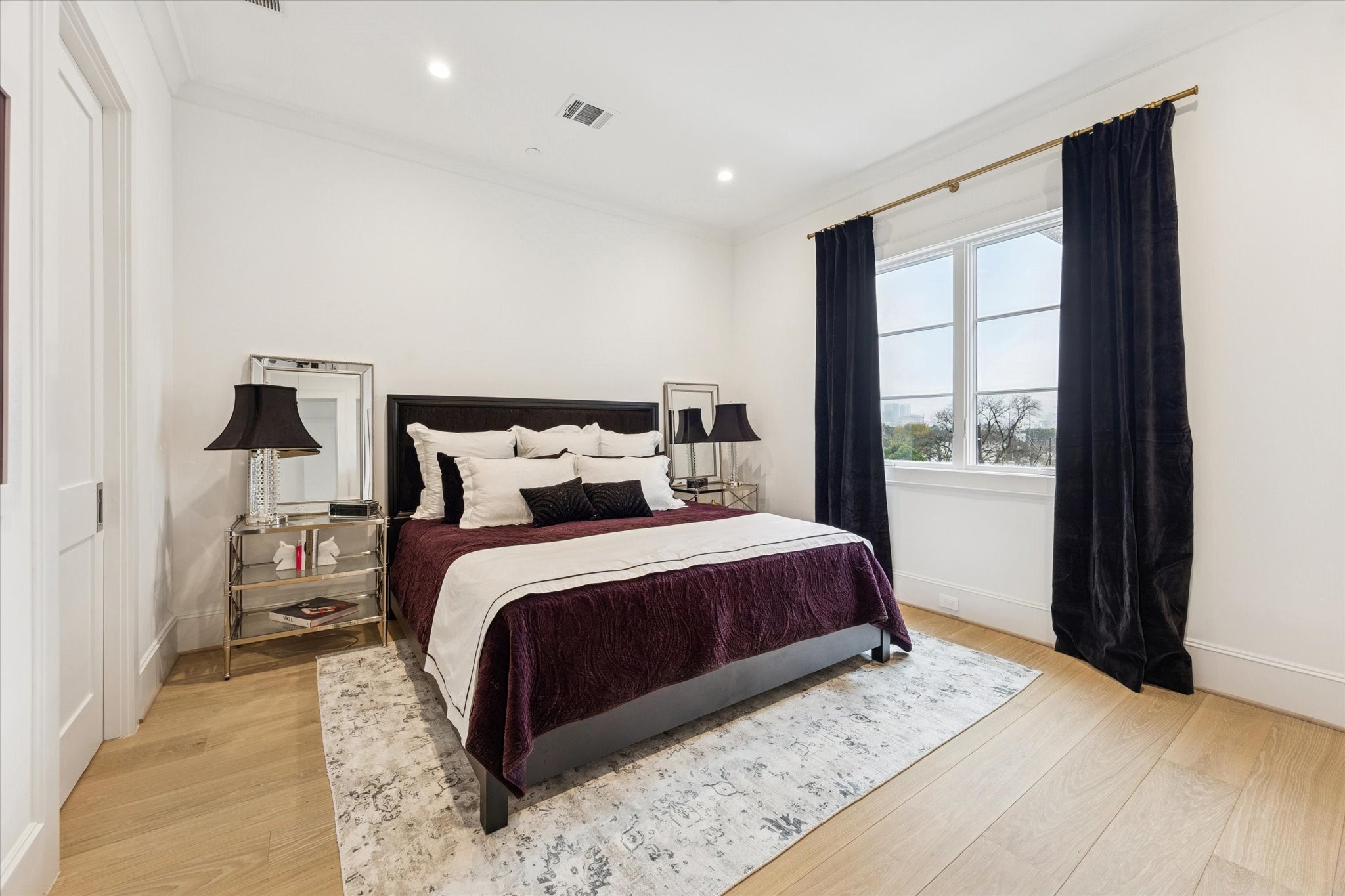 1335 Peden Street Houston, TX 77019 - Photo 27 of 37 a bedroom with a large bed and a large window