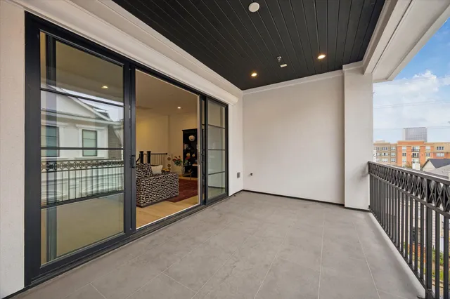 a view of a hallway with wooden floor and door