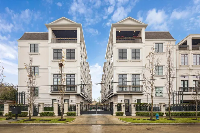 a front view of a residential apartment building with a yard