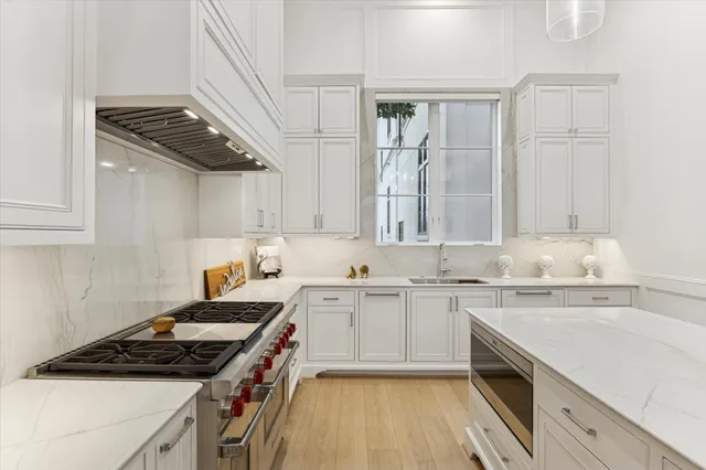 a kitchen with a sink a stove and cabinets