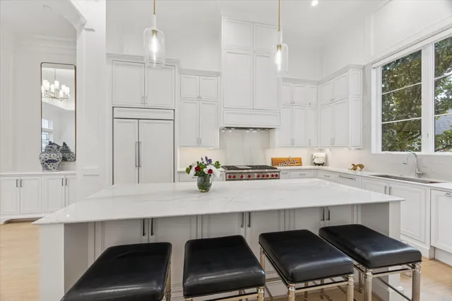 a kitchen with granite countertop a stove a table and chairs in it