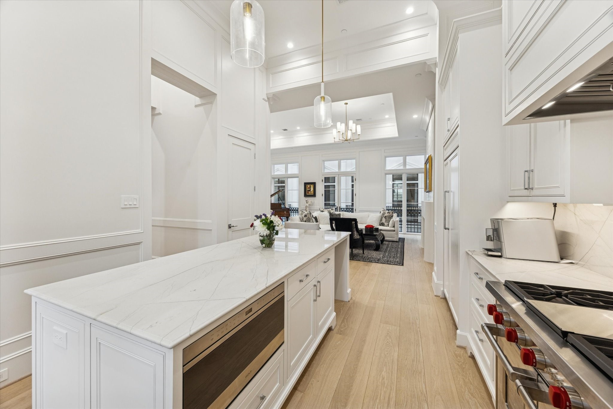 1335 Peden Street Houston, TX 77019 - Photo 8 of 37 a large white kitchen with a stove a sink a refrigerator and a dining table view