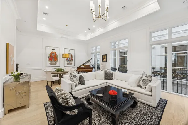a living room with furniture ceiling fan and a rug