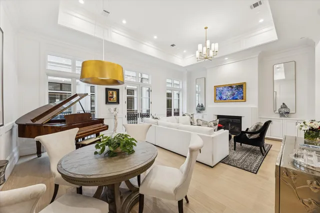 a view of a dining room with furniture and a chandelier