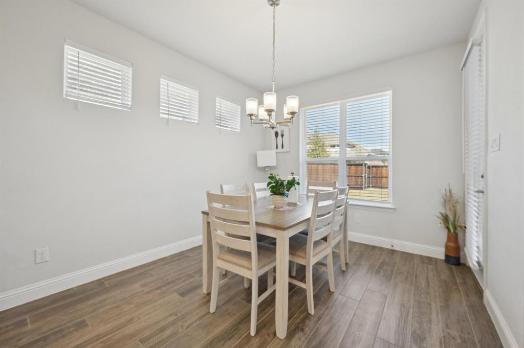 2172 Poppyvine Road Frisco, TX 75033 - Photo 11 of 40 Dining space featuring dark wood-style flooring and suspended lighting