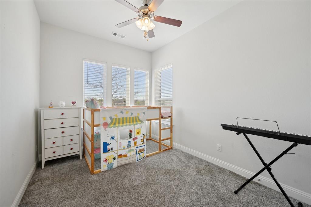 2172 Poppyvine Road Frisco, TX 75033 - Photo 18 of 40 Unfurnished bedroom featuring carpet and a ceiling fan