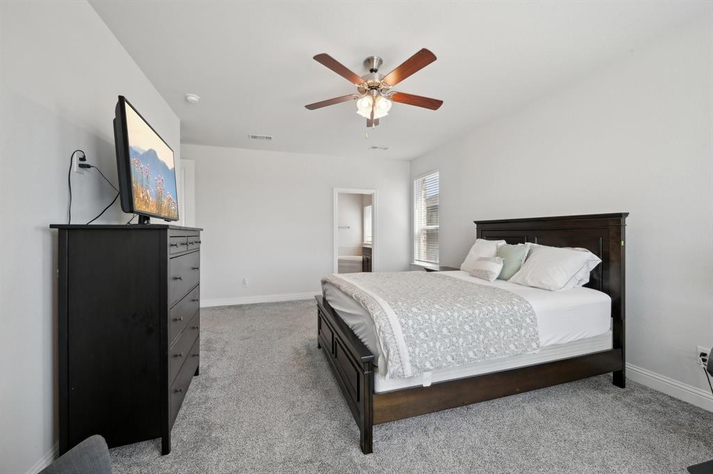 2172 Poppyvine Road Frisco, TX 75033 - Photo 22 of 40 Bedroom with a ceiling fan, light carpet, and connected bathroom