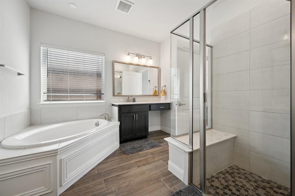 2172 Poppyvine Road Frisco, TX 75033 - Photo 24 of 40 Full bath featuring a garden tub, a stall shower, vanity, and wood tiled floors