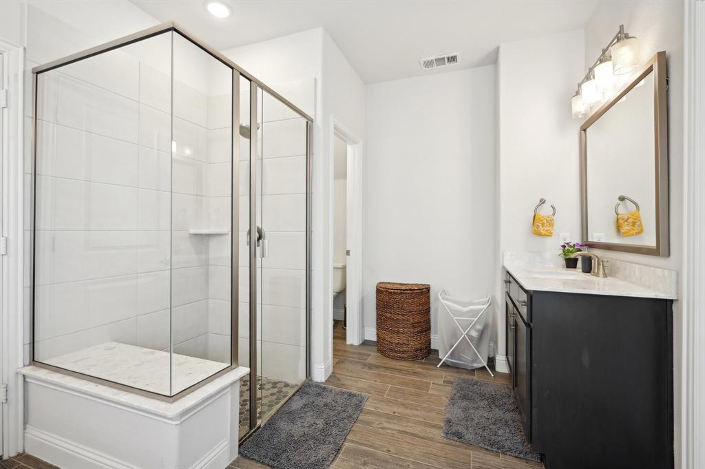 2172 Poppyvine Road Frisco, TX 75033 - Photo 25 of 40 Bathroom featuring vanity, dark wood-type flooring, a shower stall, and recessed lighting