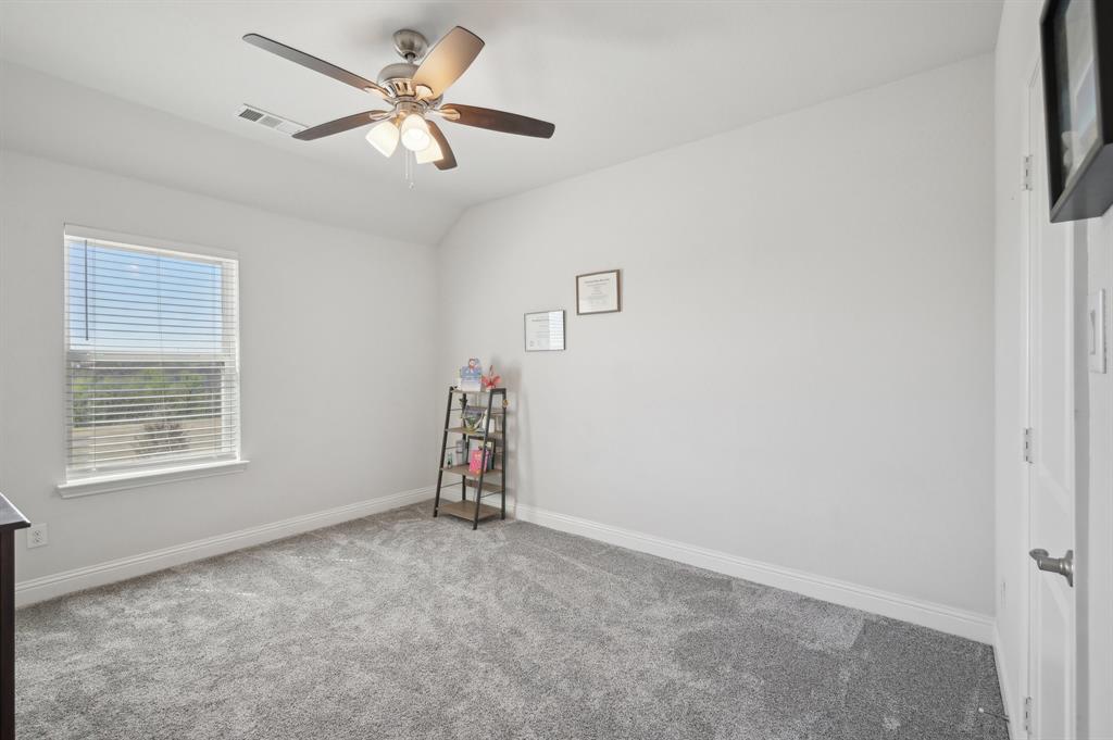 2172 Poppyvine Road Frisco, TX 75033 - Photo 26 of 40 Empty room featuring light colored carpet, vaulted ceiling, and ceiling fan