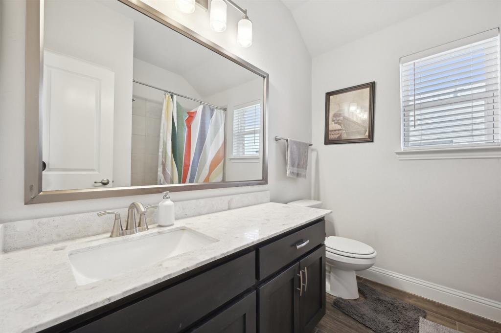 2172 Poppyvine Road Frisco, TX 75033 - Photo 28 of 40 Full bath with vanity, vaulted ceiling, a shower with curtain, and dark wood-style flooring