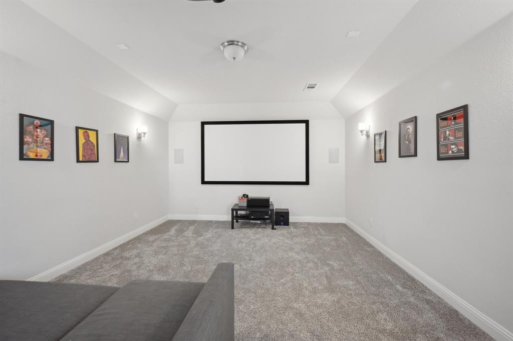 2172 Poppyvine Road Frisco, TX 75033 - Photo 31 of 40 Home theater featuring carpet floors and lofted ceiling