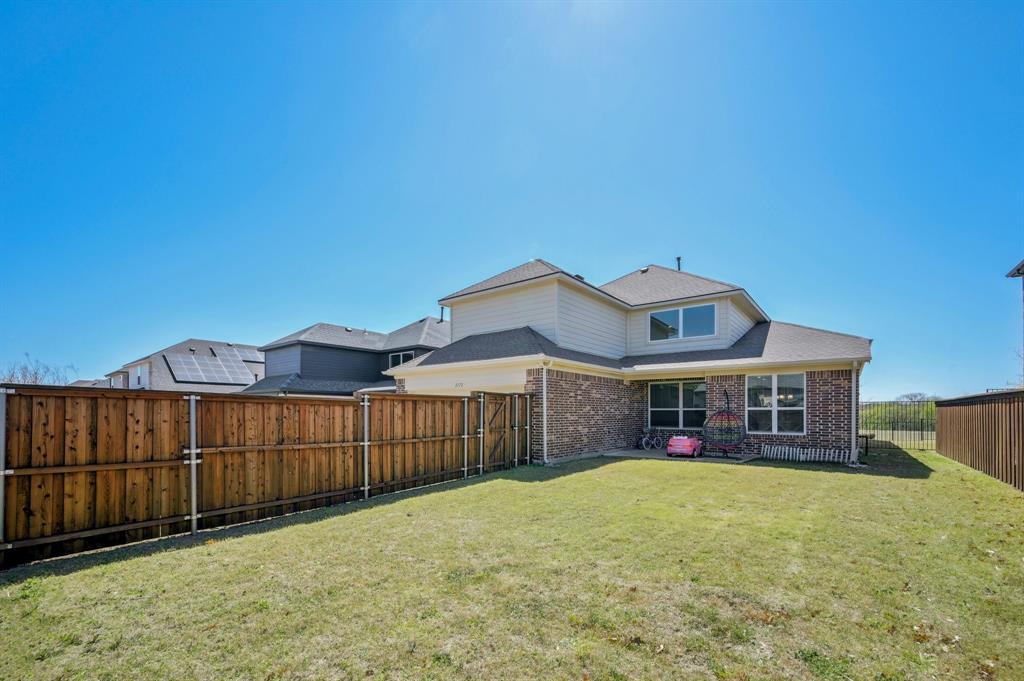 2172 Poppyvine Road Frisco, TX 75033 - Photo 35 of 40 Back of house featuring a fenced backyard and brick siding