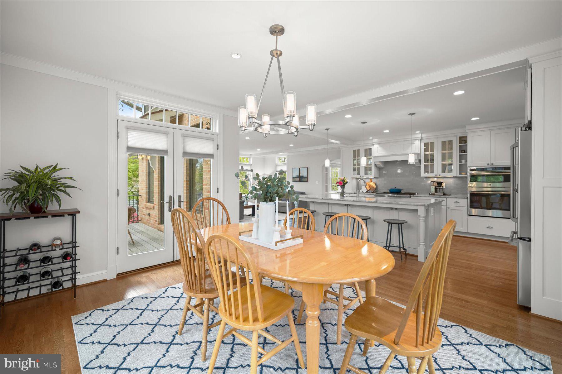 5532 14th Road North Arlington, VA 22205 - Photo 18 of 65 a dining room with furniture a chandelier and kitchen view