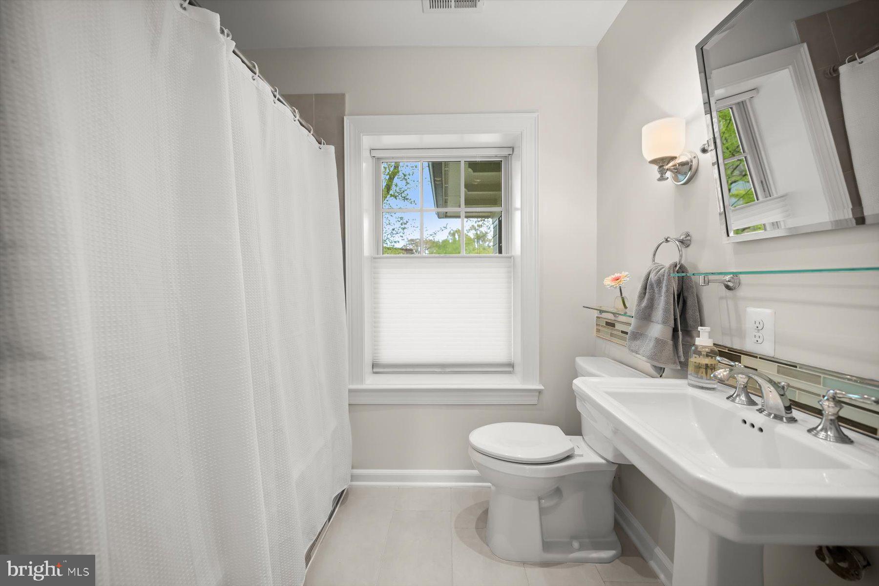 5532 14th Road North Arlington, VA 22205 - Photo 36 of 65 a bathroom with a toilet sink and mirror