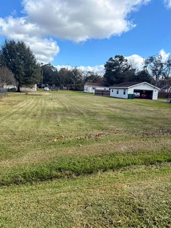 a view of a fountain is middle in the middle of a field