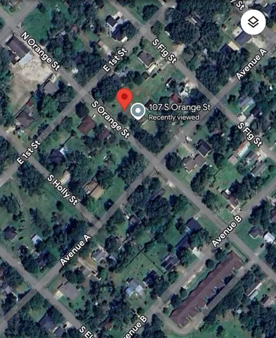 a view of a big yard with table and chairs