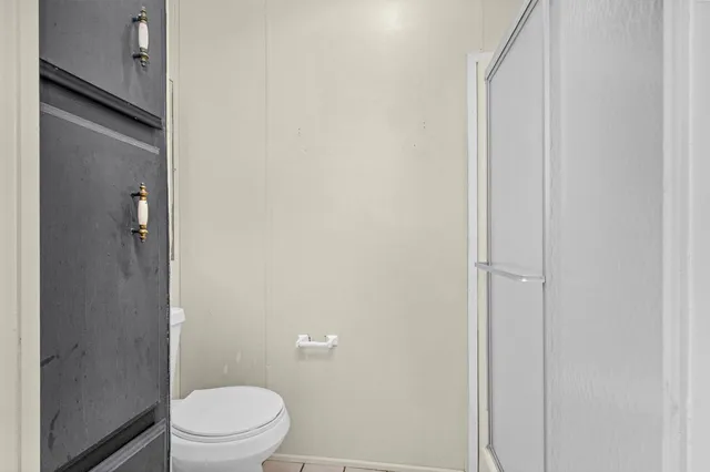 a white toilet sitting next to a bathroom sink