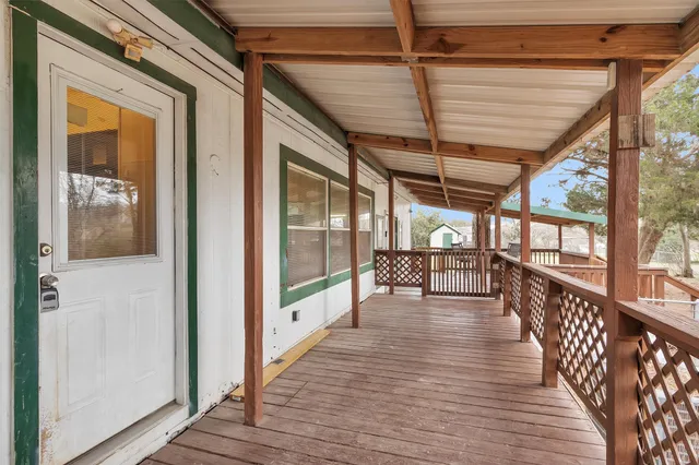 a view of a porch with wooden floor and windows