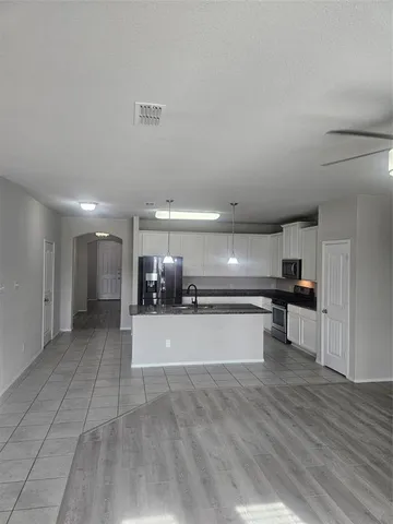 a view of a kitchen with a sink stainless steel appliances and cabinets