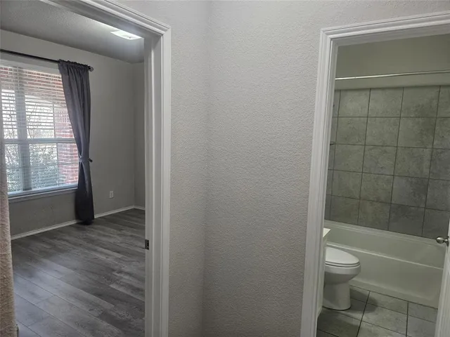 a bathroom with a granite countertop toilet a sink and a shower