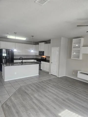 a view of kitchen with wooden floor