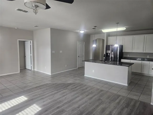 a view of kitchen with refrigerator microwave and stove