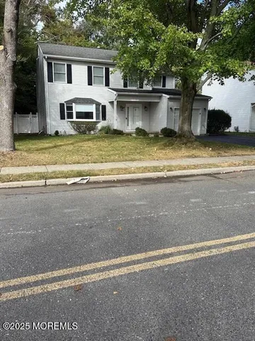 a view of a house with swimming pool and a yard