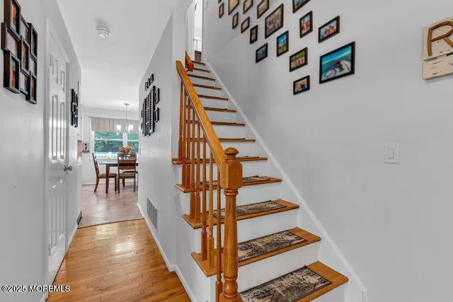 a view of entryway and hall with wooden floor