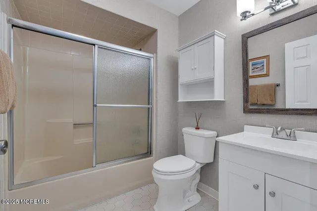 a bathroom with a toilet sink and shower