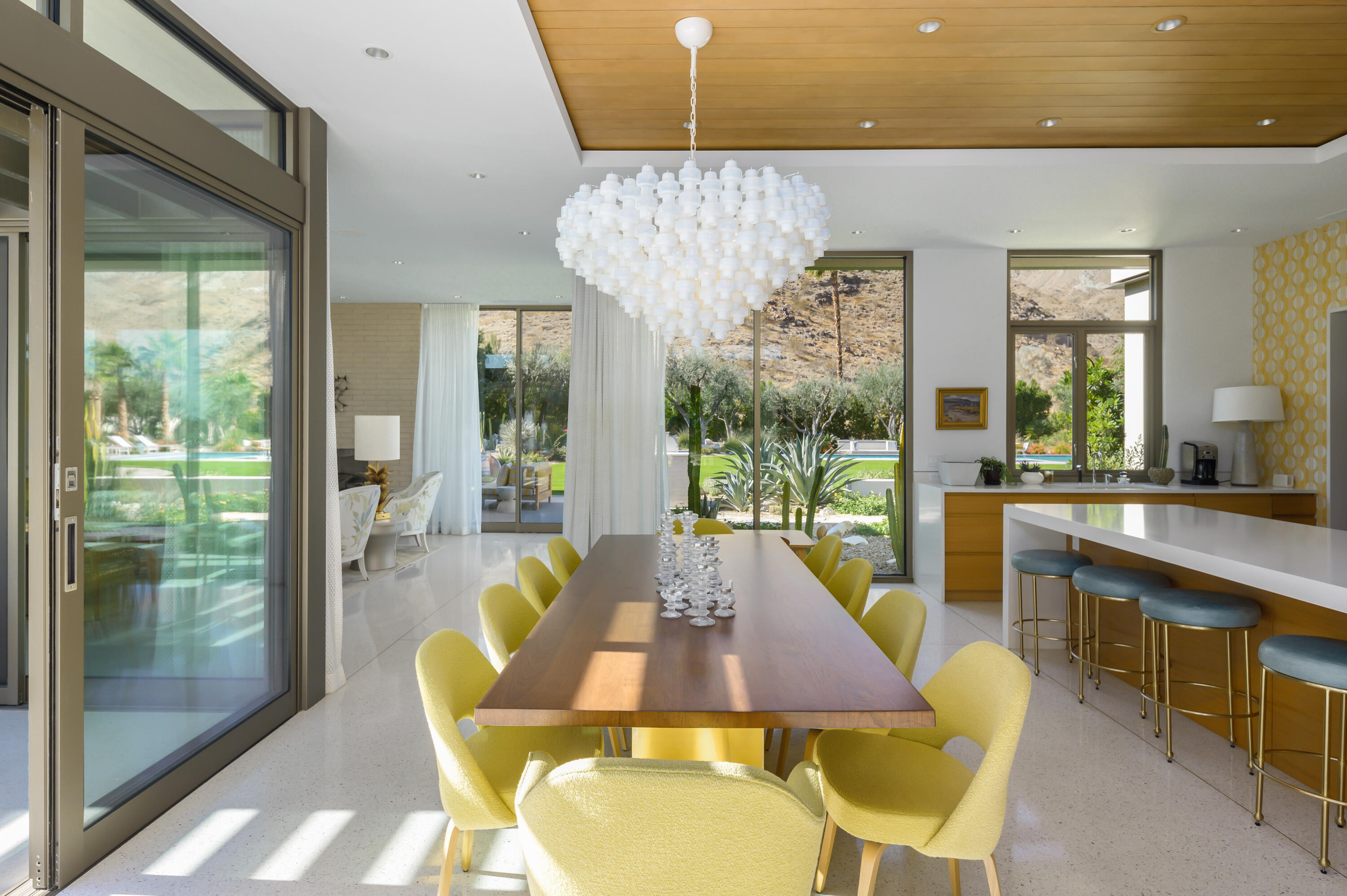 70155 Carson Road Rancho Mirage, CA 92270 - Photo 15 of 56 a view of a dining room with furniture wooden floor and a chandelier