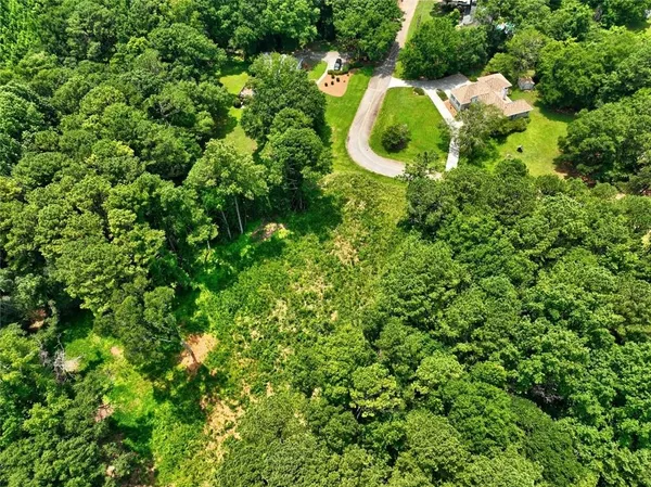 a aerial view of a house with a yard and garden