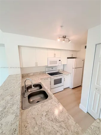 a kitchen with a sink cabinets and appliances