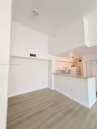 a view of a kitchen with wooden floor