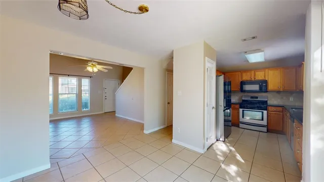 a kitchen with granite countertop a refrigerator and a counter top space