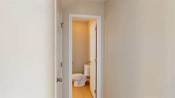 an empty room with closet and a ceiling fan