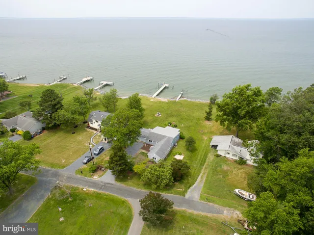 an aerial view of a house with a yard basket ball court and outdoor seating