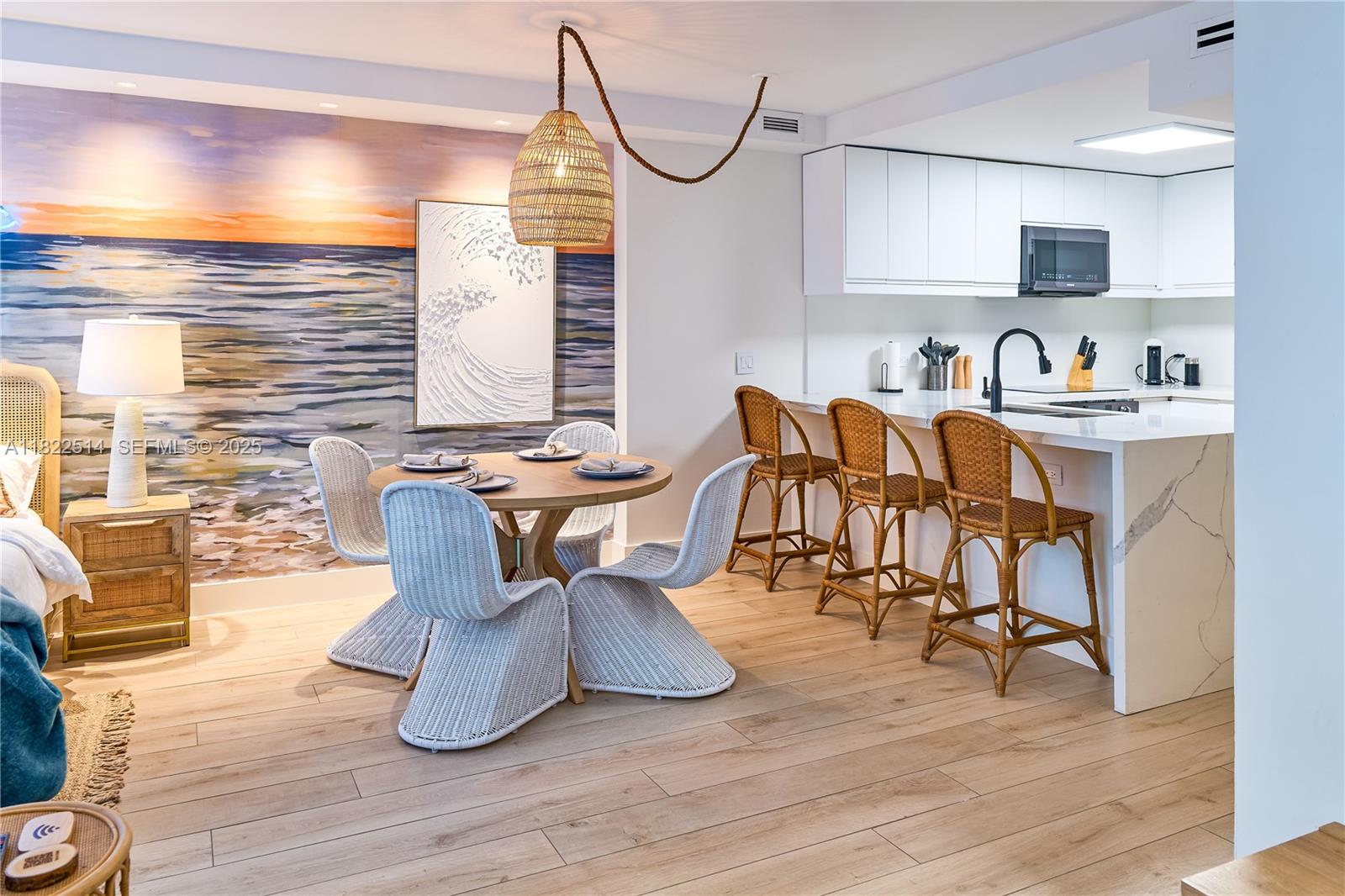 2301 Collins Avenue, Unit 329 Miami Beach, FL 33139 - Photo 2 of 47 a view of a dining room with furniture and wooden floor
