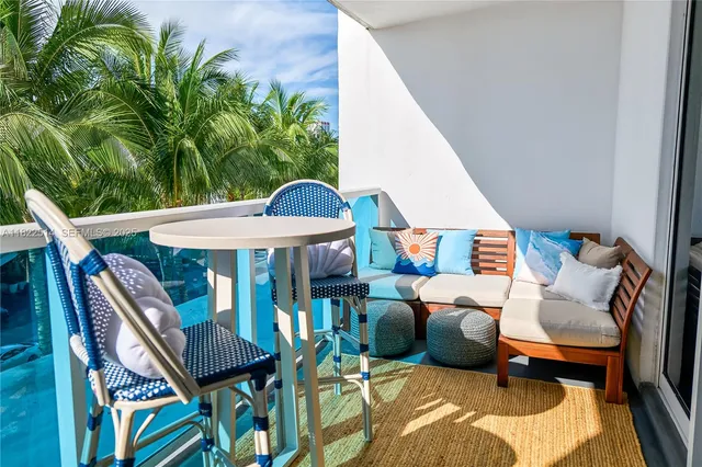 a kitchen with stainless steel appliances granite countertop a refrigerator a stove a sink dishwasher and white cabinets with wooden floor