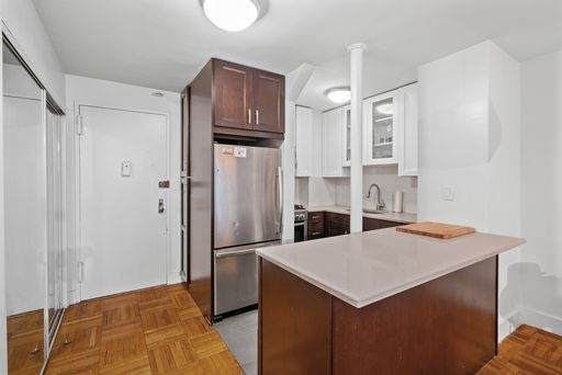 a kitchen with stainless steel appliances a refrigerator and cabinets