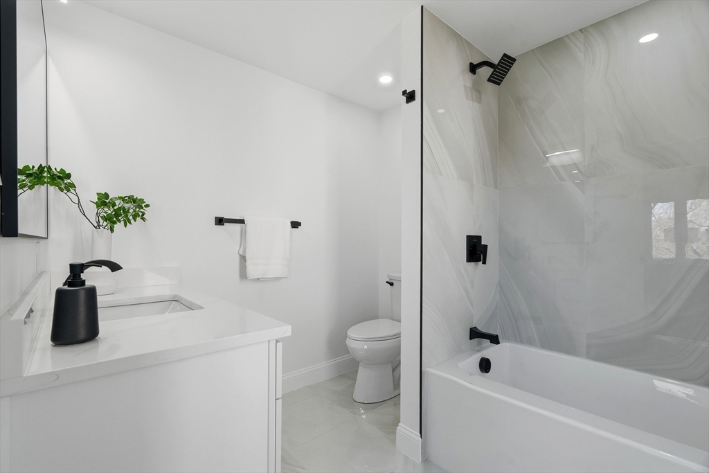171 Shaw Road Brookline, MA 02467 - Photo 15 of 42 a bathroom with a tub a sink a toilet and shower