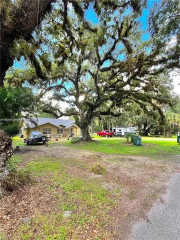 a view of a field of grass and trees