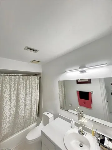 a bathroom with a sink toilet and mirror
